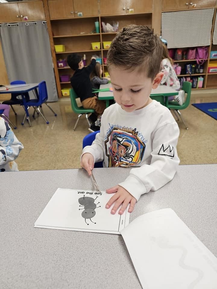 Young child drawing in classroom