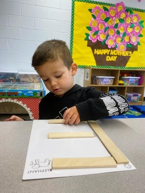 Toddler drawing at classroom table